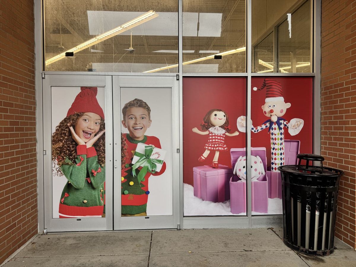 Seasonal retail brand graphics applied across a storefront window by Good Graphics Co.