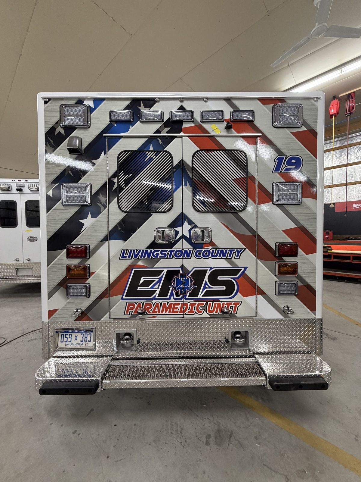 Reflective conspicuity striping and graphics on a Livingston County EMS paramedic unit installed by Good Graphics Co.